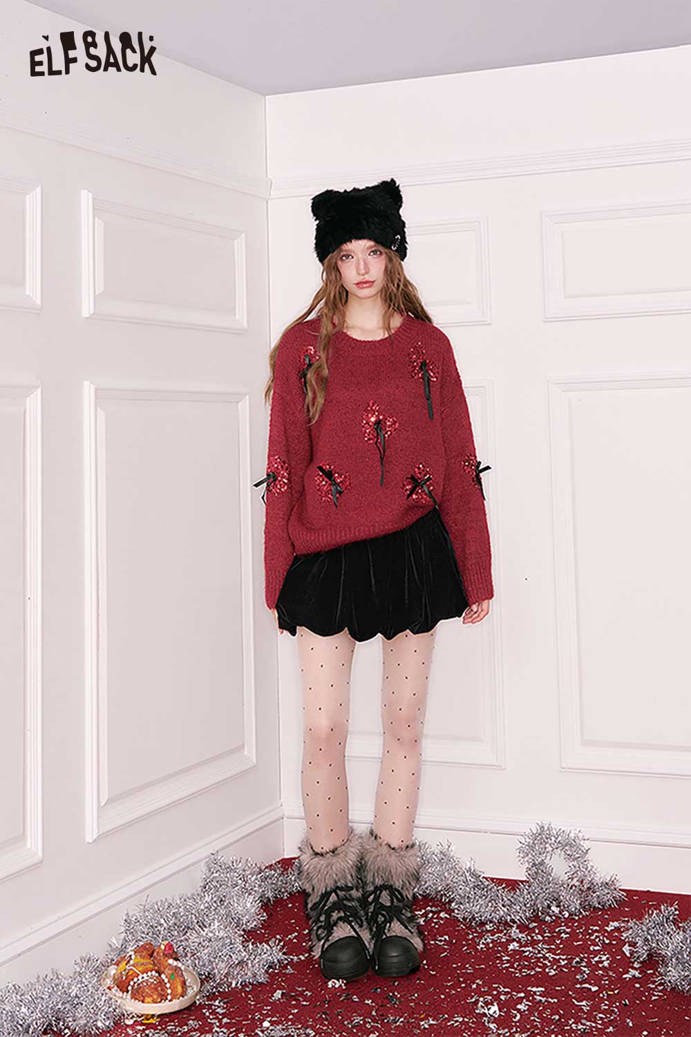 ELFSACK 3D bow embellished cropped sweater in maroon, styled with a black skirt and trendy winter accessories.