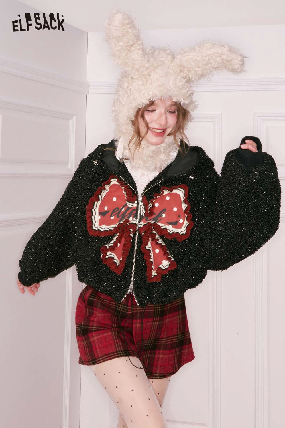 ELFSACK 3D bow glitter plush jacket with oversized sleeves and playful design for cozy style