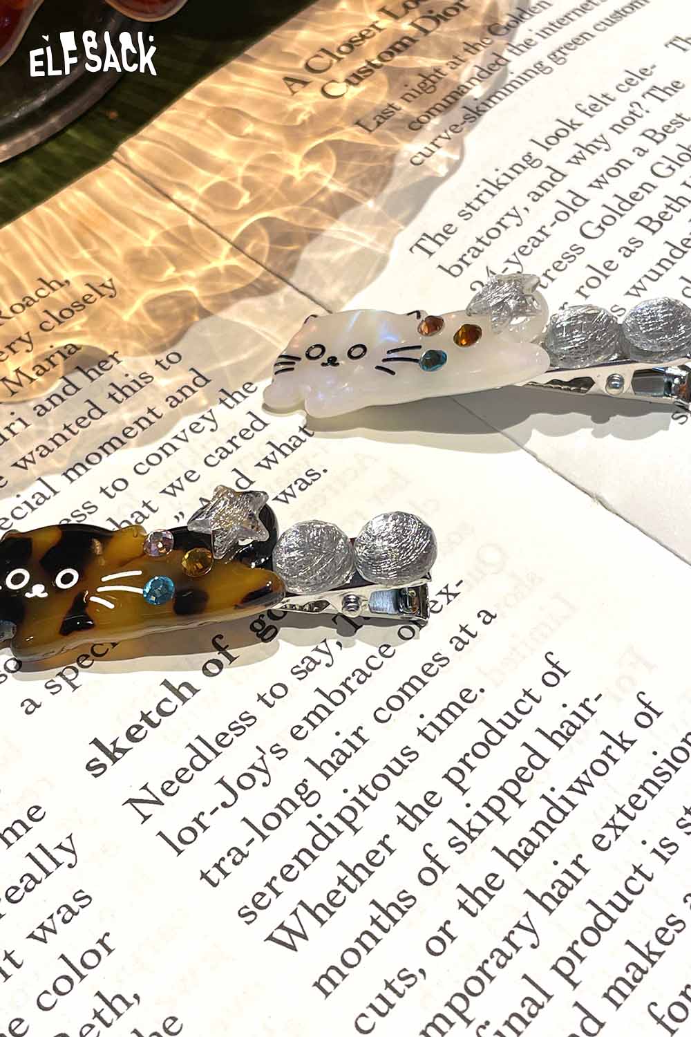 Two ELFSACK acetate kitten hairpins featuring playful cat designs with sparkling accents