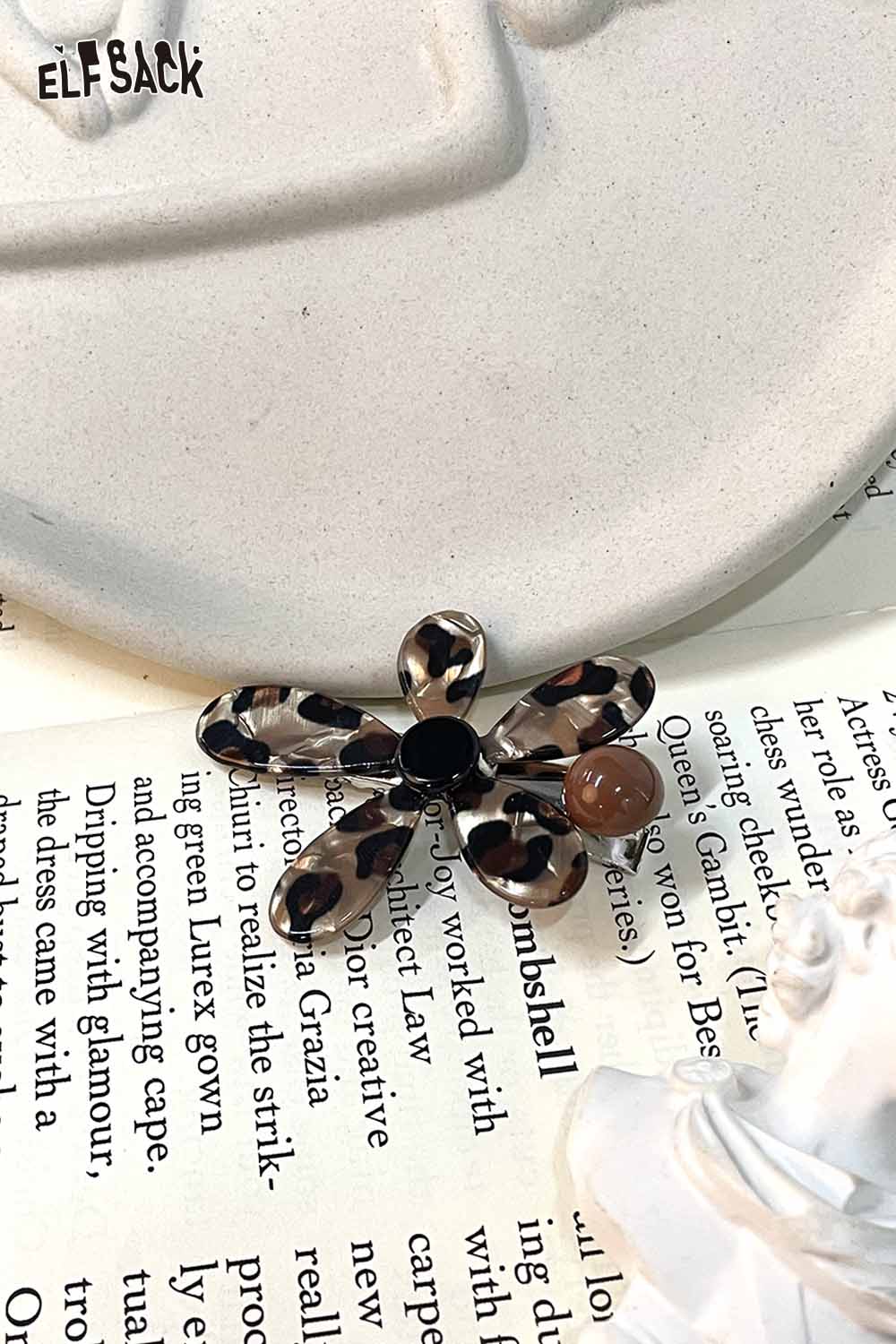 ELFSACK asymmetric floral hairpin in a stylish design featuring a blend of black and brown patterns