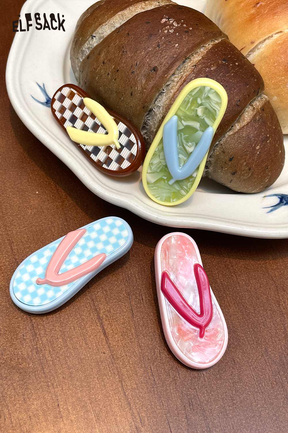 ELFSACK set of 4 flip flop shaped korean cute hair clip accessories in pastel patterns on a plate