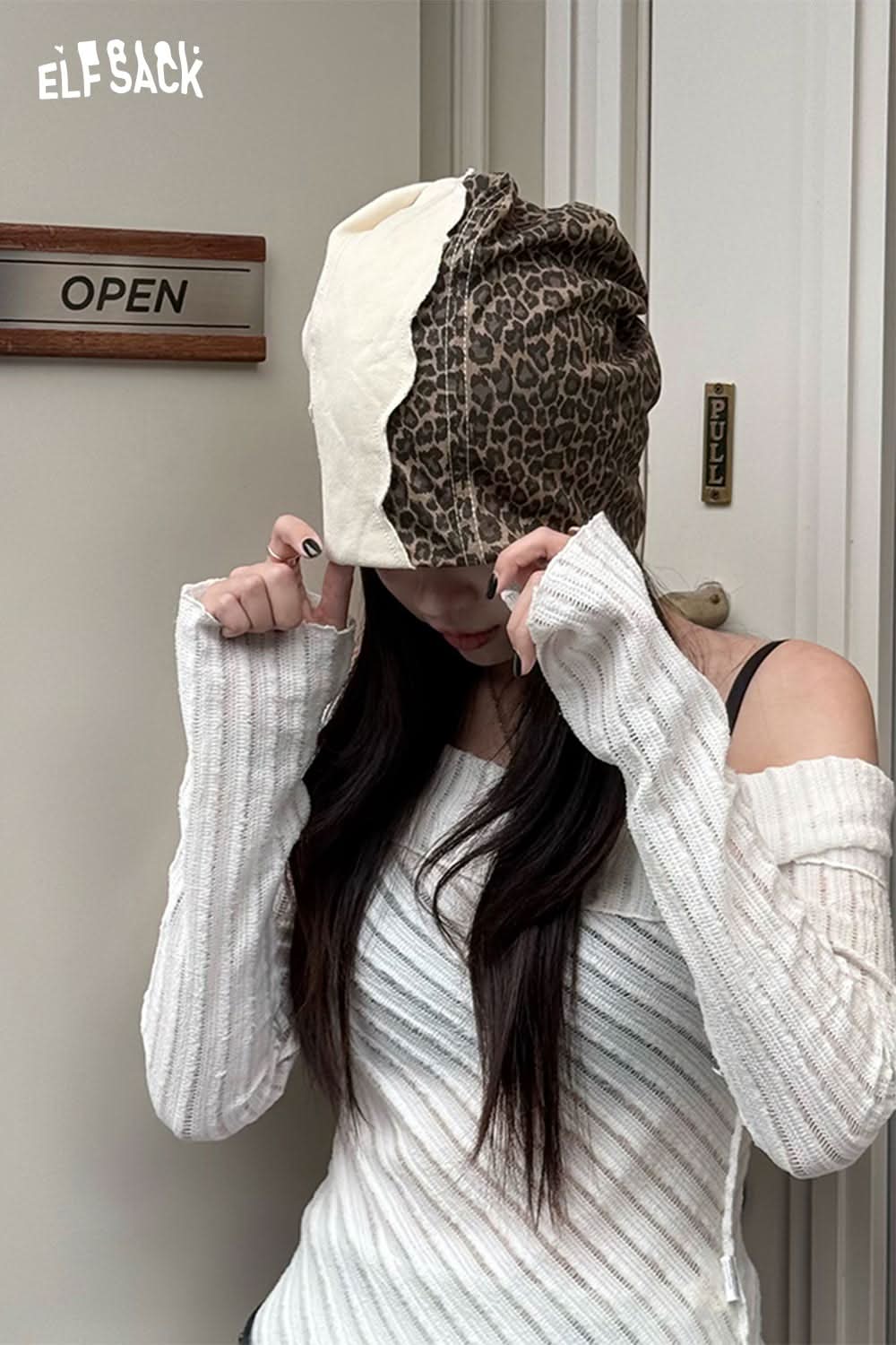 ELFSACK animal print slouchy beanie on model with white sweater, featuring a stylish design