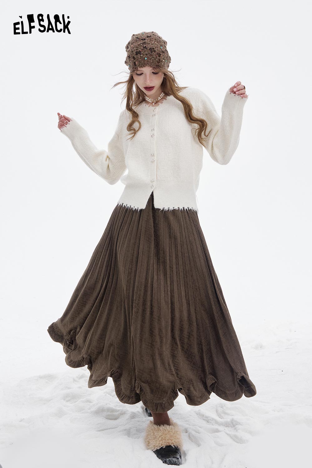 ELFSACK asymmetric flounce hem skirt in brown, styled with a cozy white cardigan and winter accessories