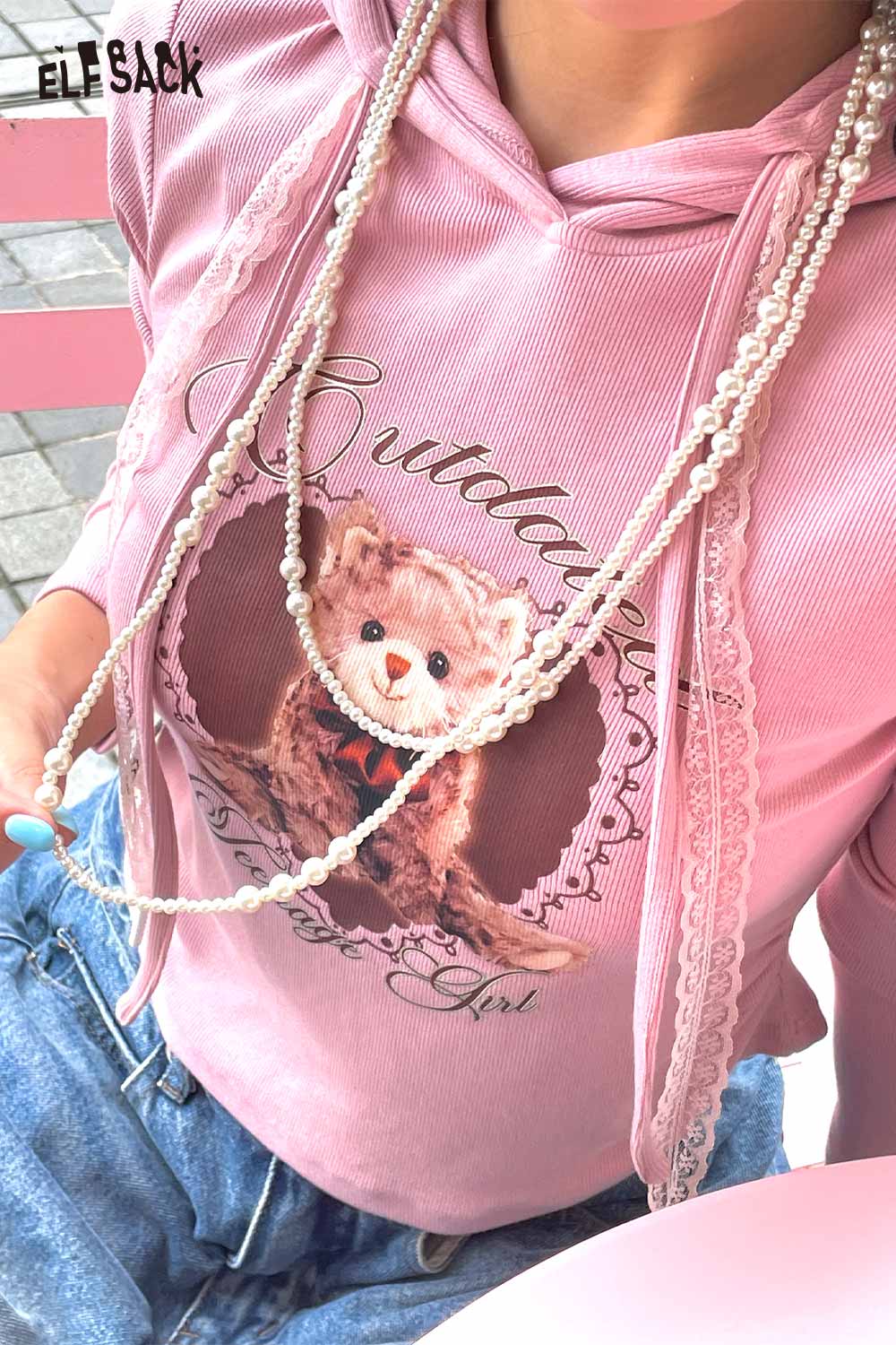 Pink hoodie with bear graphic and baroque pearl cluster necklace for stylish casual wear