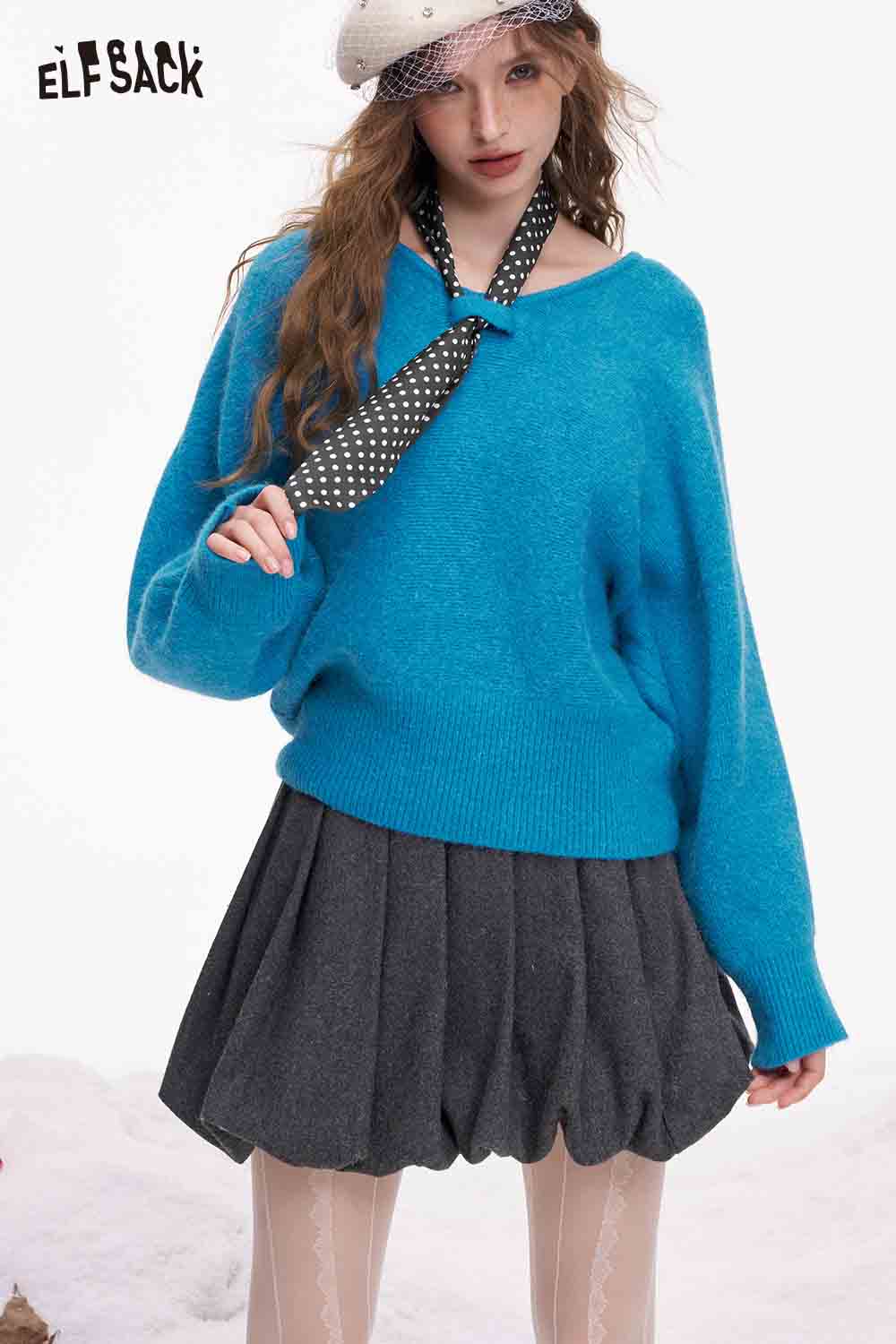 ELFSACK bat sleeve polka dot sweater in bright blue paired with a gray pleated skirt and stylish accessories