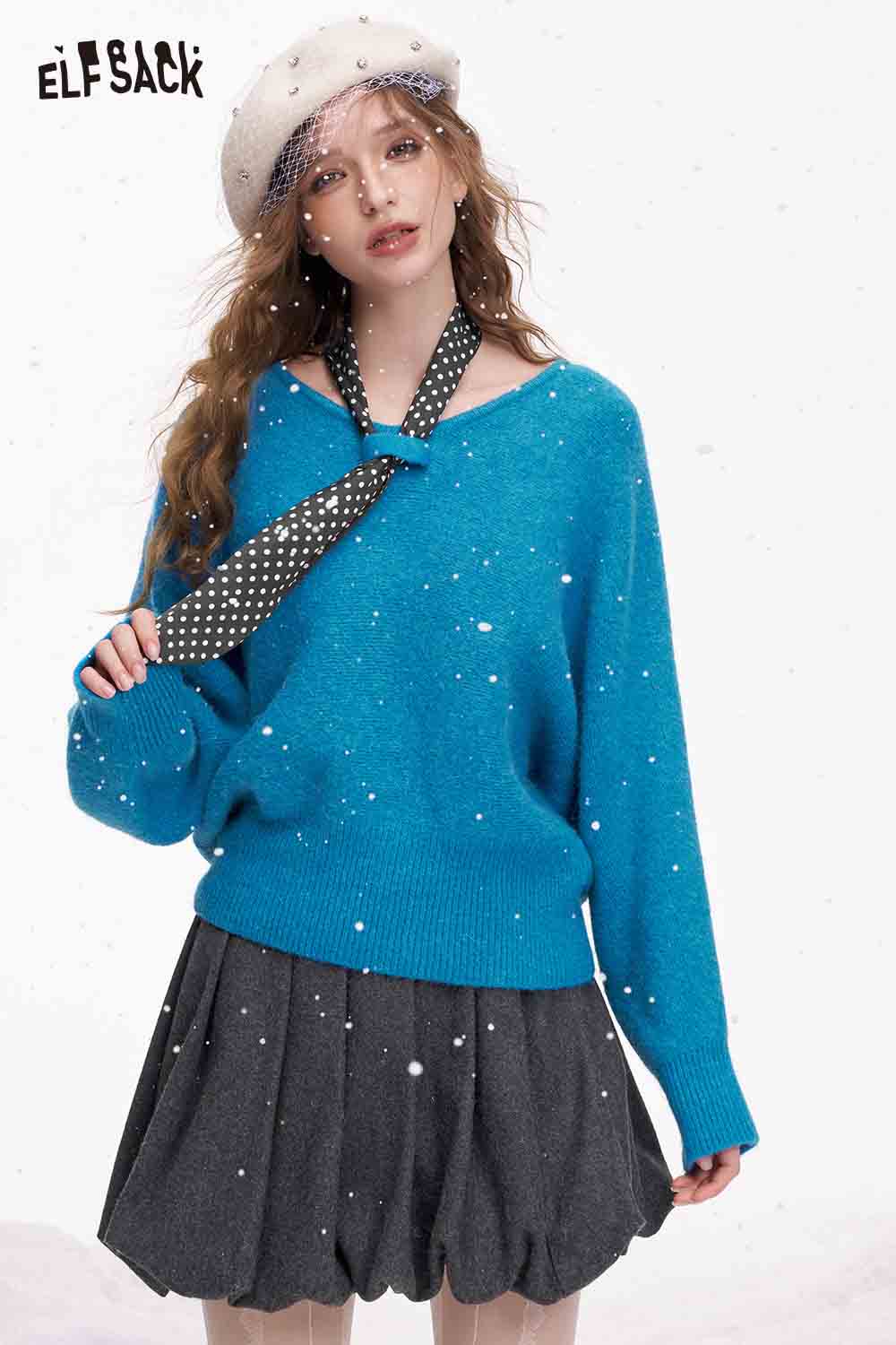ELFSACK bat sleeve polka dot sweater in blue, styled with a neck scarf and a gray skirt.
