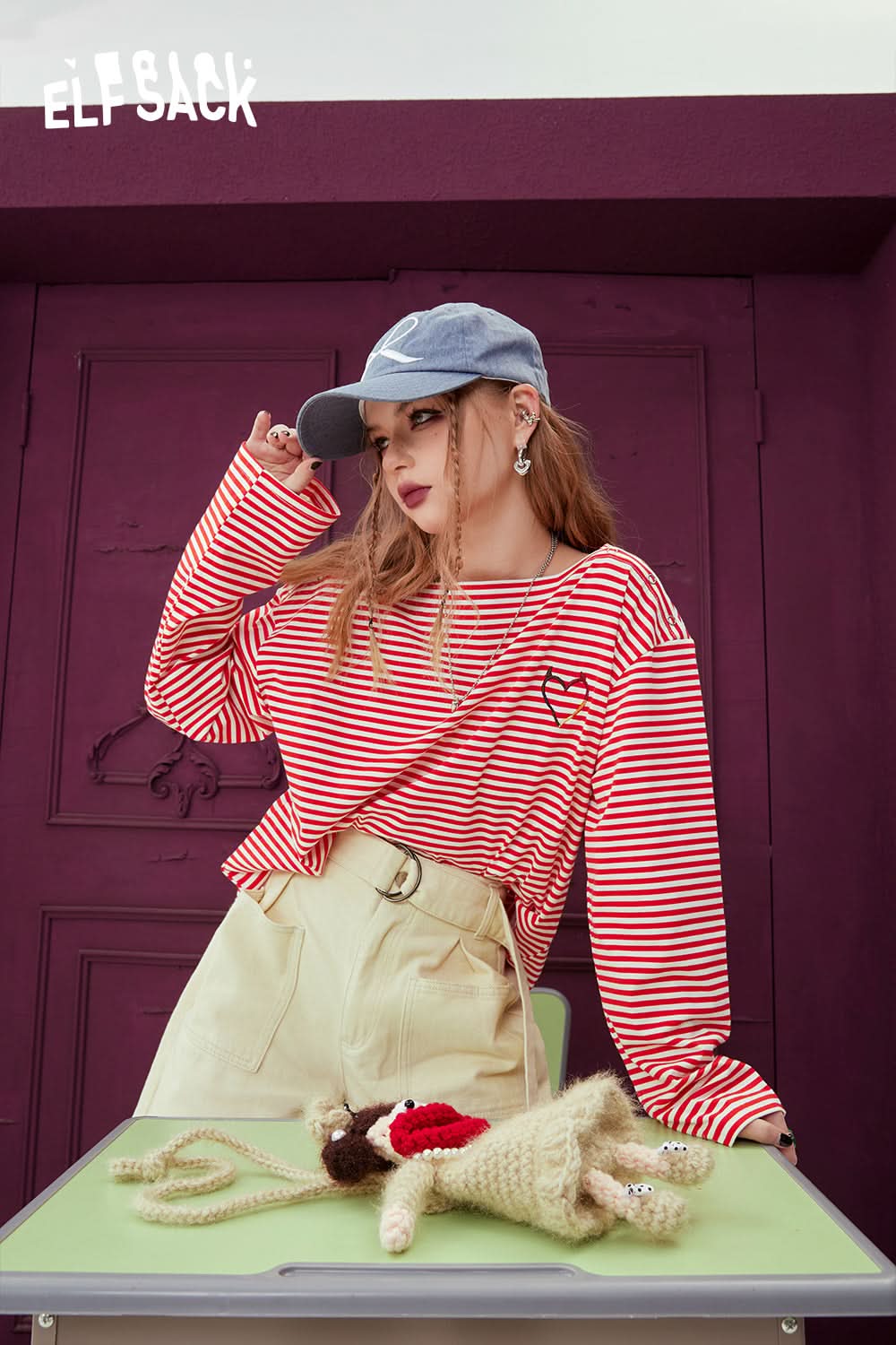 ELFSACK black & white striped long sleeve t-shirt styled with beige pants and a blue cap