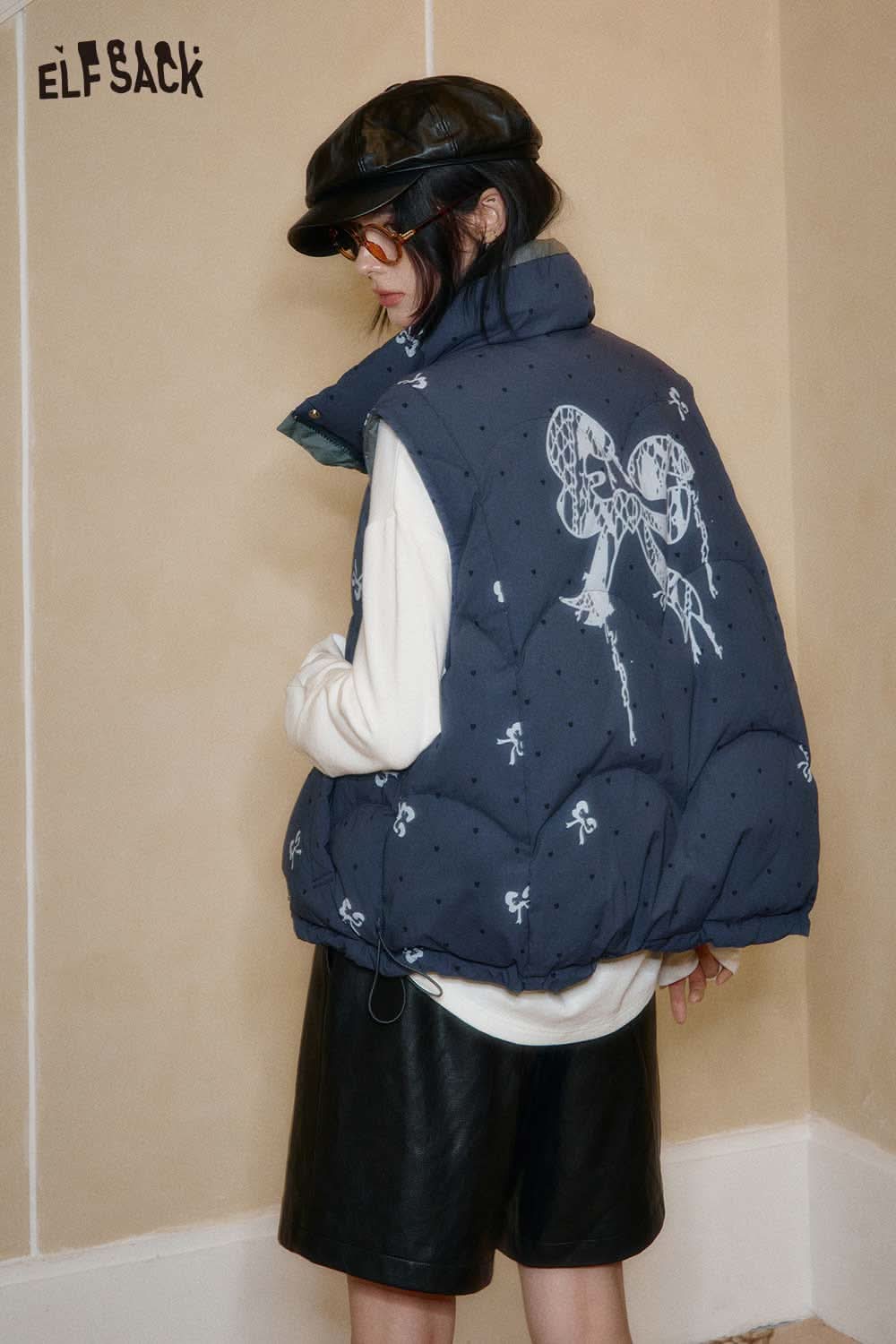 ELFSACK bohemian floral reversible vest in navy with playful prints, perfect for layering in style.