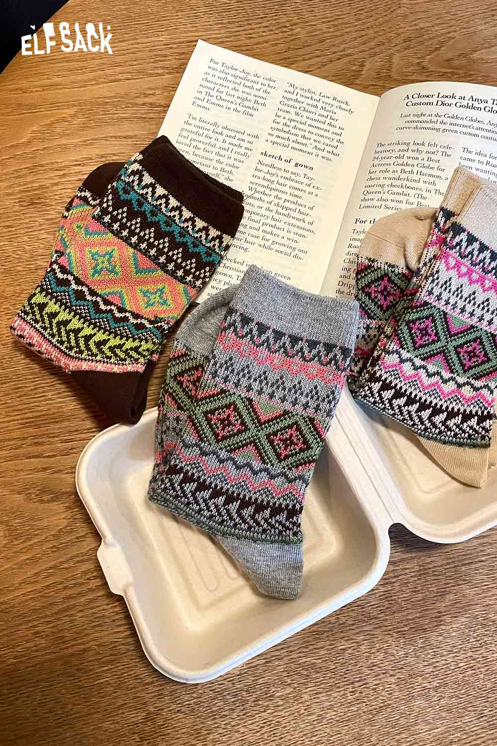 Colorful ELFSACK bohemian stripe socks for women in a variety of patterns displayed on a wooden table