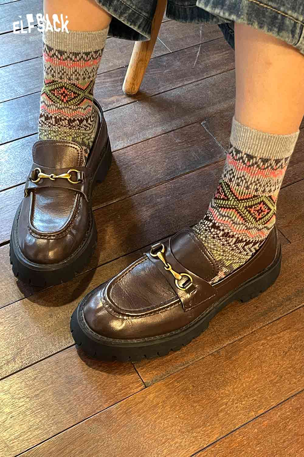 Stylish ELFSACK bohemian stripe socks for women paired with brown loafers on wooden floor
