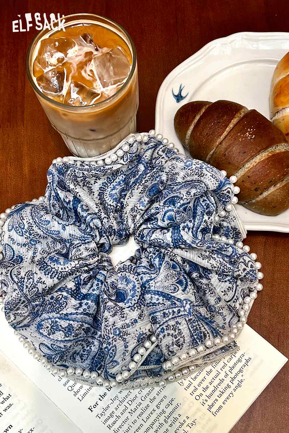 ELFSACK boho floral pearl hair band blue paisley scrunchie with pearl trim beside iced coffee and croissant