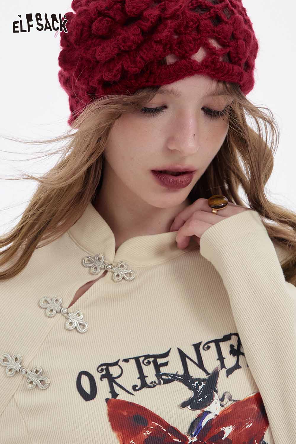 ELFSACK bow graphic long sleeve tshirt in cream with decorative floral accents and a stylish design