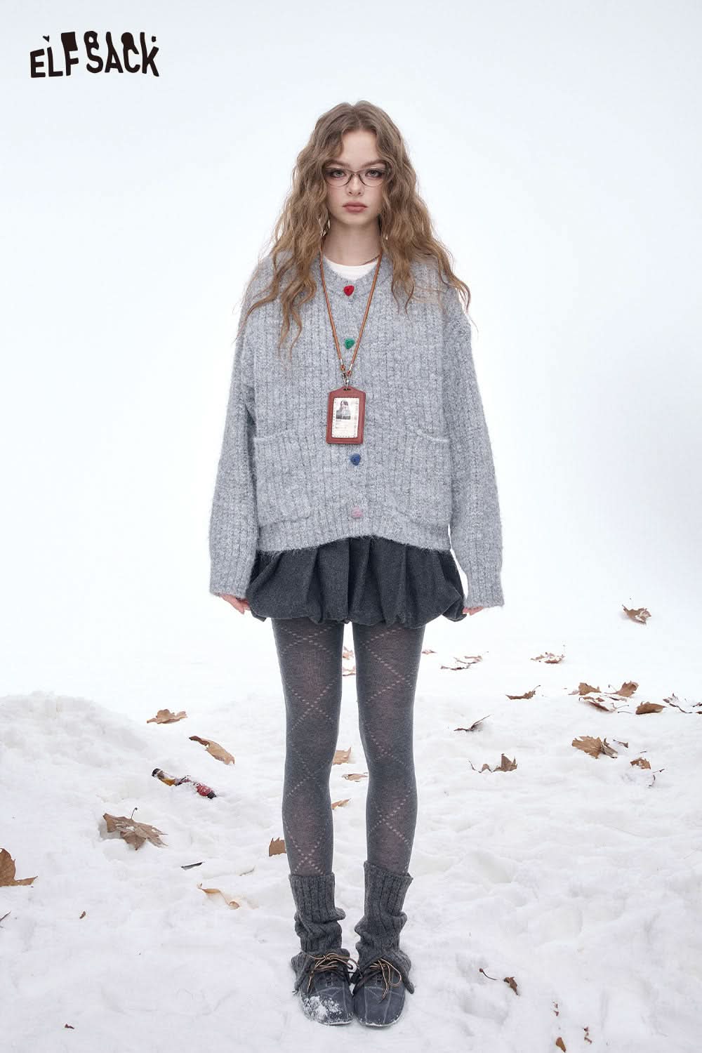 Fashion model wearing cozy outfit with breathable mesh leggings for women and layered gray sweater