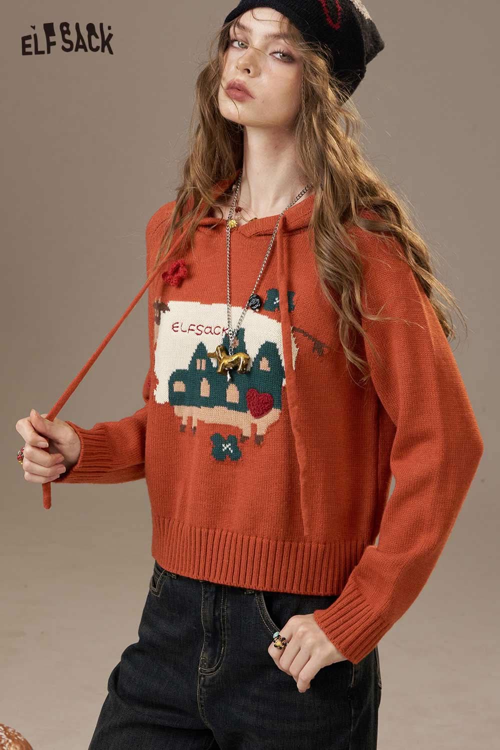 ELFSACK cartoon cow print hooded sweater in orange with playful graphic design and cozy fit