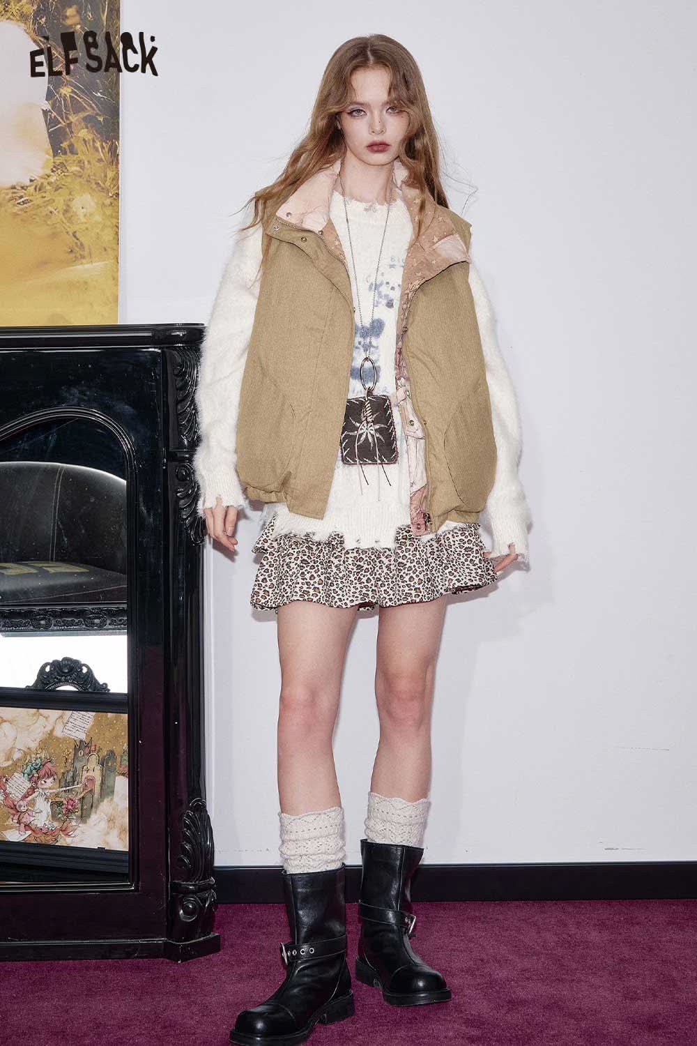 ELFSACK cartoon graphic puffer vest paired with a stylish skirt and boots for a trendy winter look