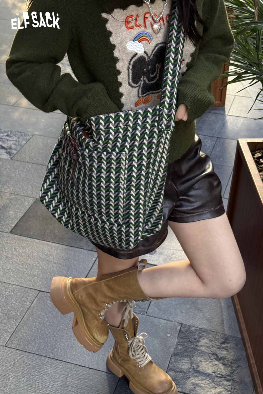 Fashionable model showcasing a casual striped crossbody bag with a trendy design and stylish outfit