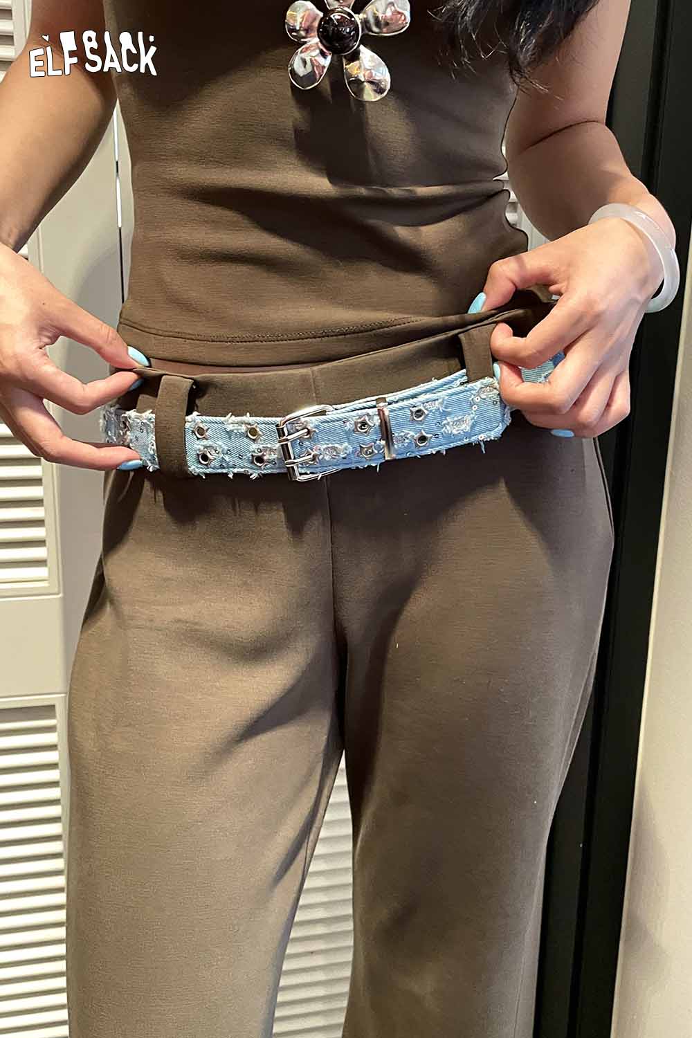 ELFSACK celestial motif leather belt for women styled with a chic outfit and a unique design