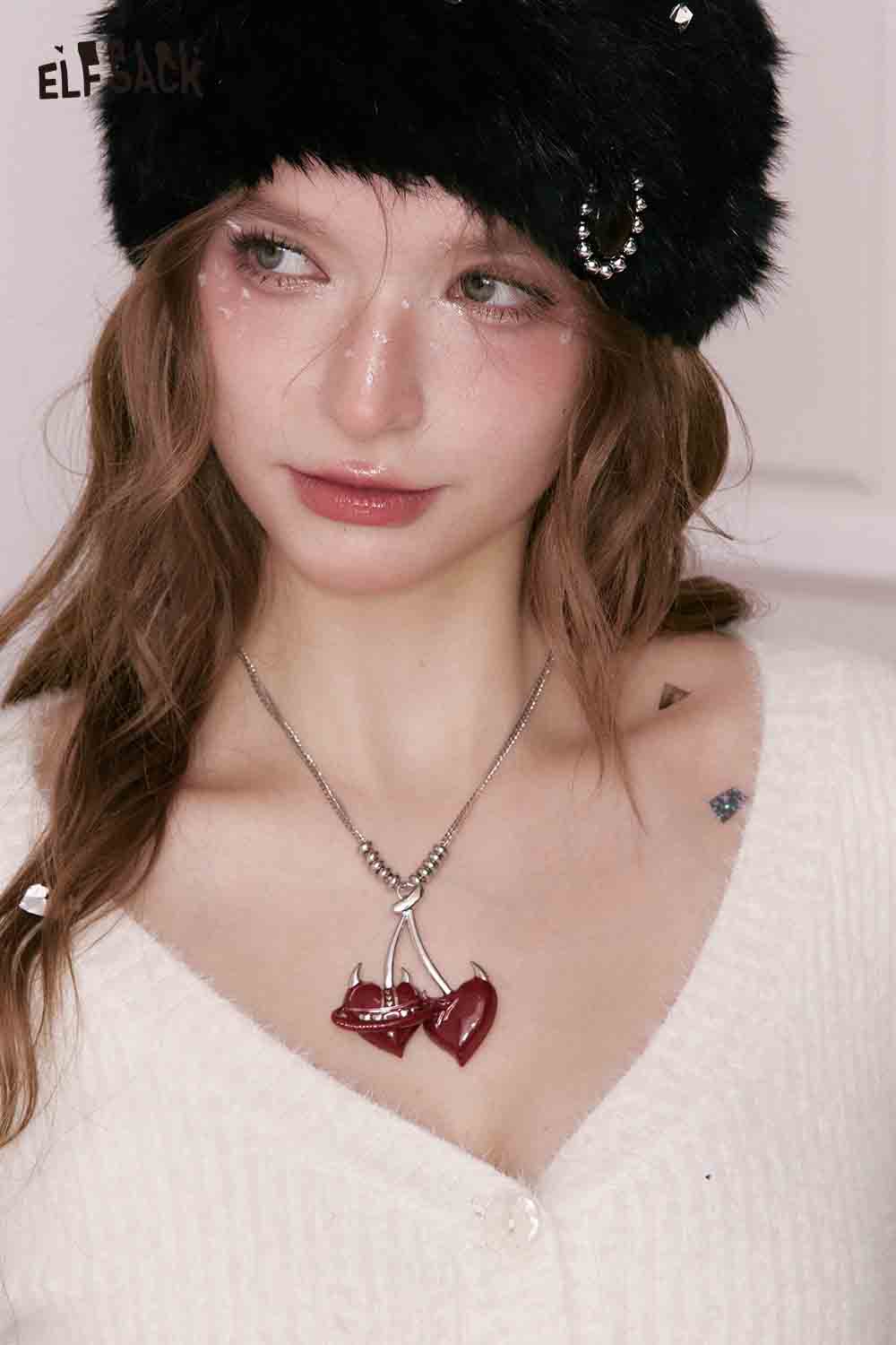 ELFSACK cherry pendant heart necklace showcased on a model wearing a cozy top and stylish hat