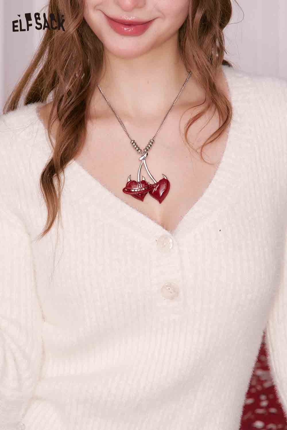 ELFSACK cherry pendant heart necklace with red hearts and silver accents worn on a cozy sweater