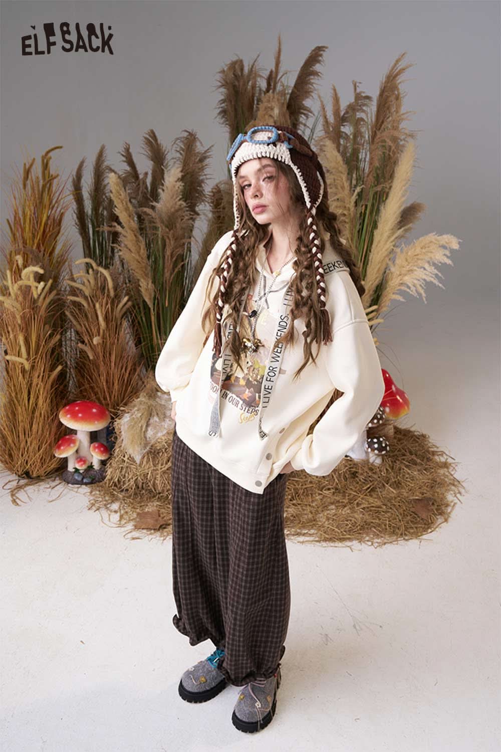 ELFSACK color blocked crocheted ear flap beanie styled with a cozy oversized sweatshirt and relaxed pants