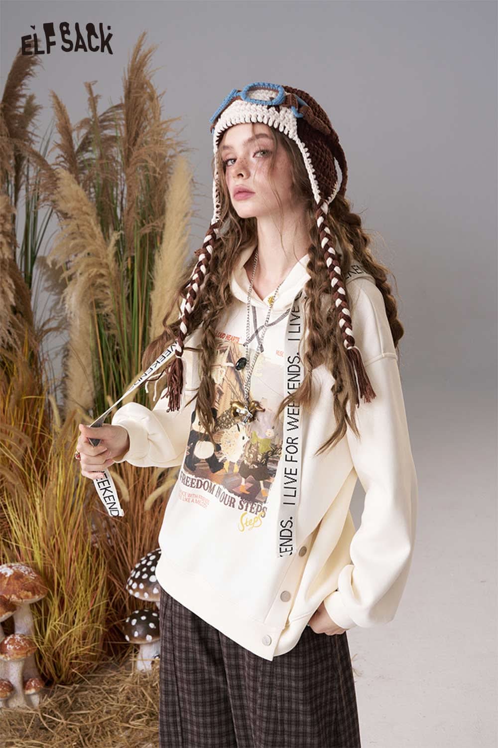 ELFSACK color blocked crocheted ear flap beanie with braided tassels and playful design for stylish winter wear
