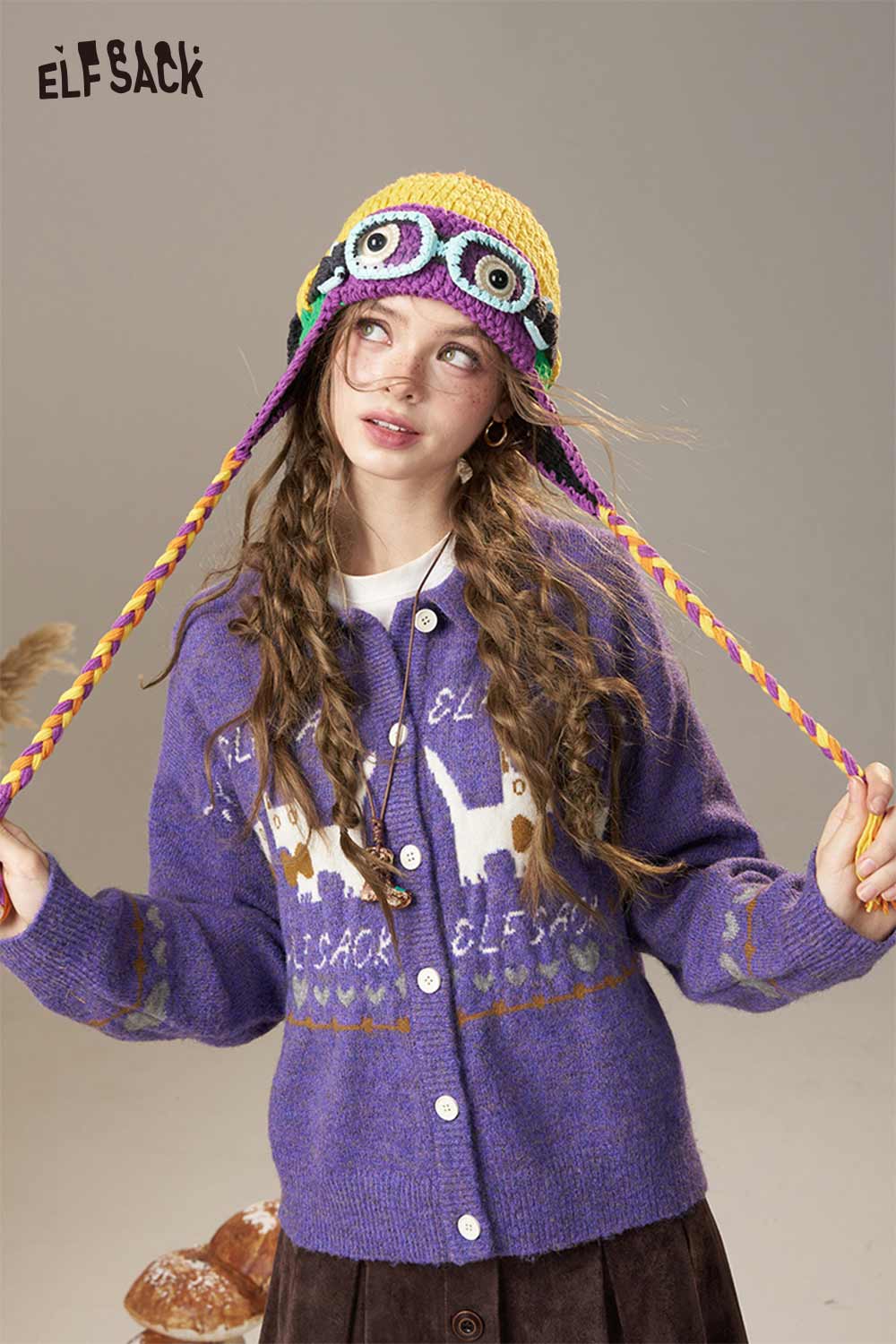 Color blocked crocheted ear flap beanie in vibrant colors with braided ties for a fun winter accessory