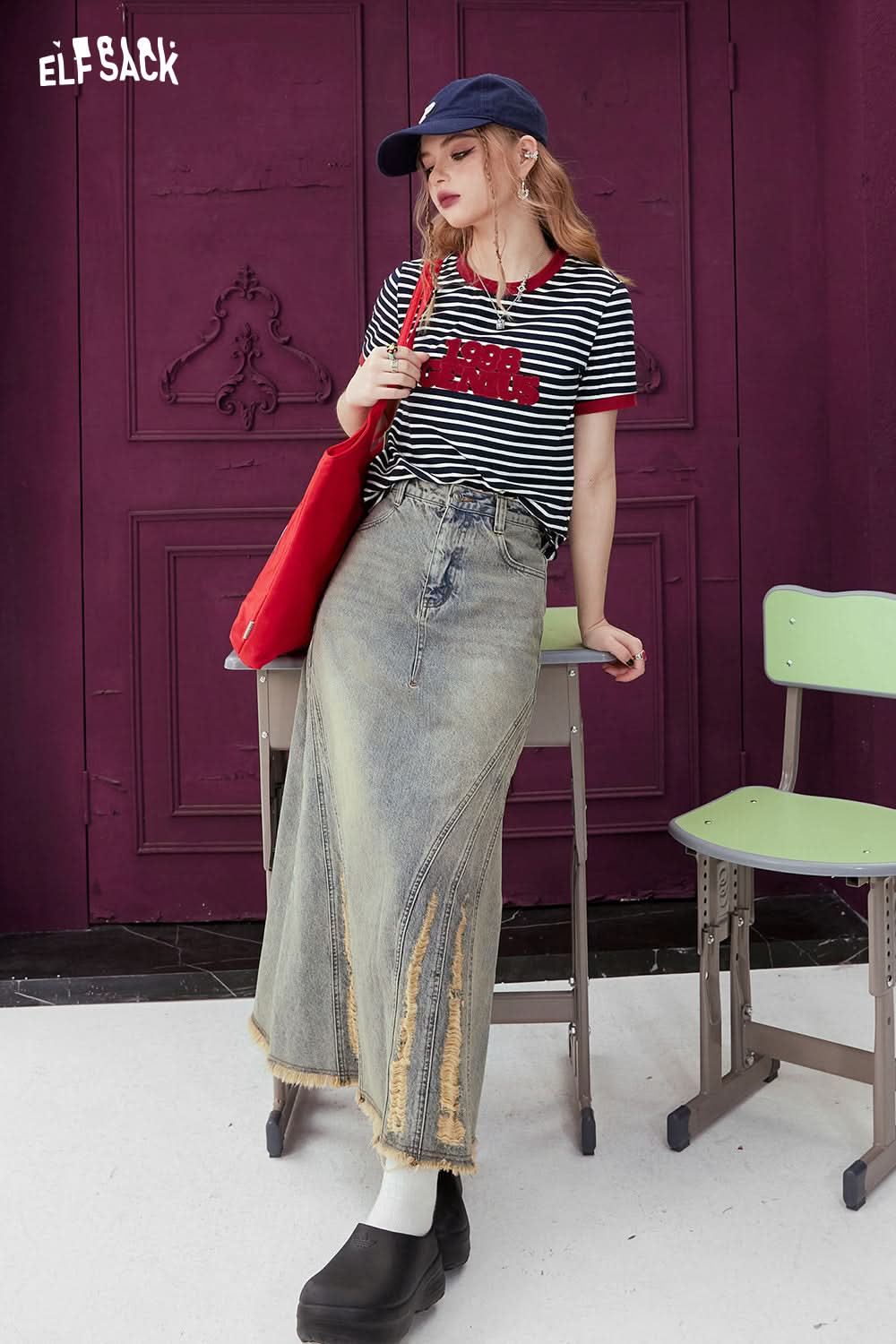 ELFSACK T-shirt with Contrasting Stripe pattern in black and white worn with a denim skirt and red bag