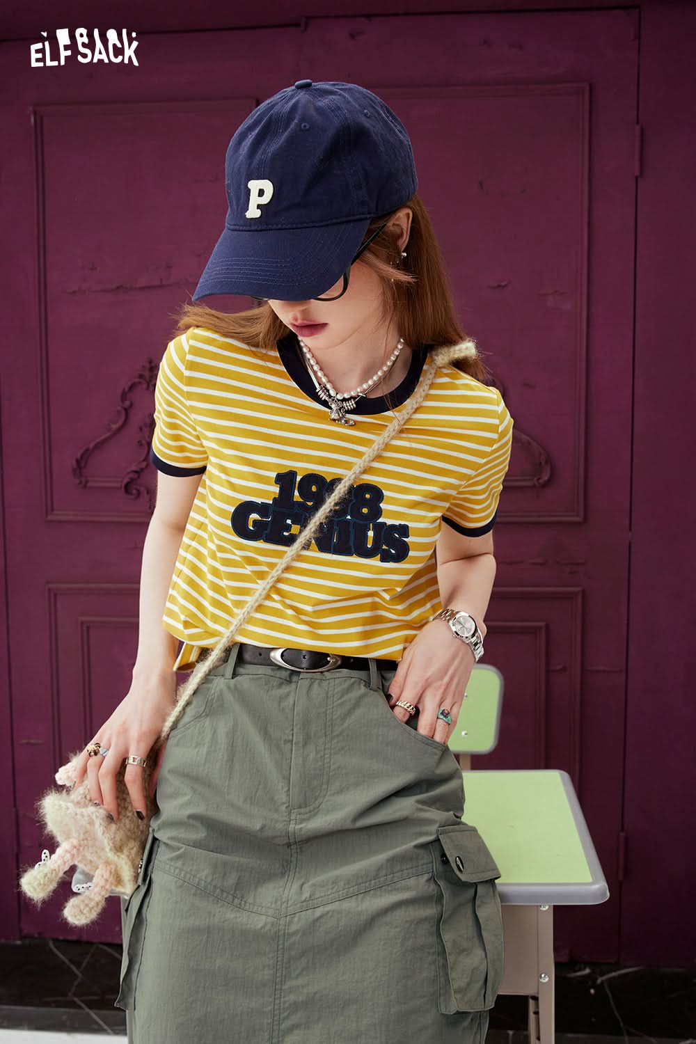 ELFSACK yellow T-shirt with Contrasting Stripe and graphic 1988 design worn with green cargo skirt