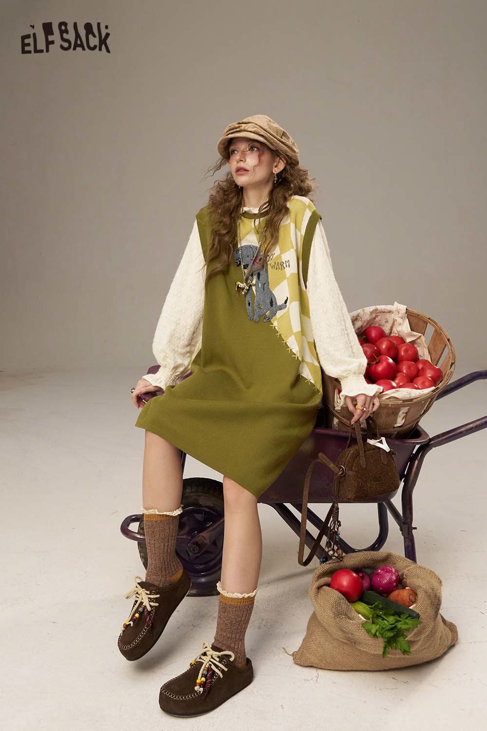 ELFSACK canine motif embroidered dress in green with playful design, styled with accessories and background props