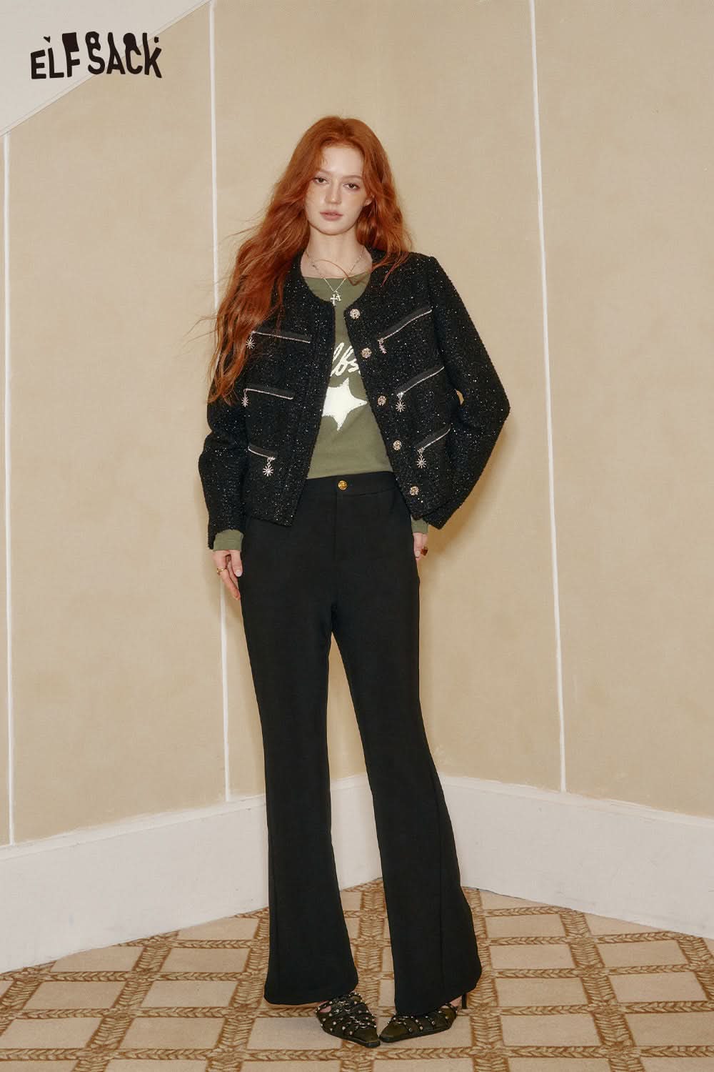 Woman wearing ELFSACK constellation stitch slim fit tee with stylish black jacket and wide-leg trousers