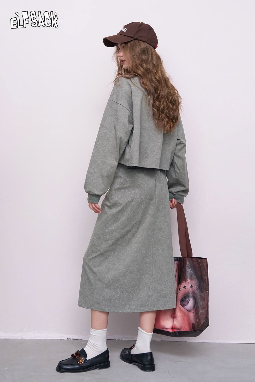 ELFSACK gray embroidered hoodie dress set on model back view with brown cap printed tote bag and loafers