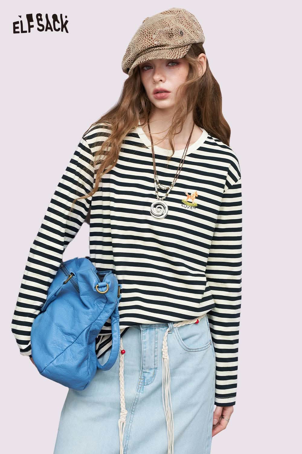 ELFSACK model wearing cotton striped long sleeve tee black and white with embroidered patch and denim skirt, blue bag
