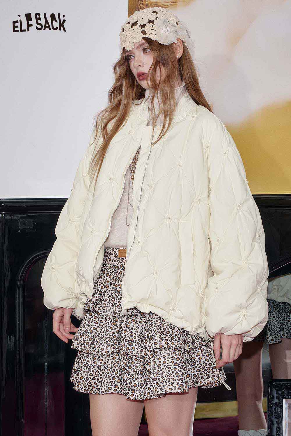 ELFSACK cream quilted mid-length jacket styled with a stylish outfit and patterned skirt