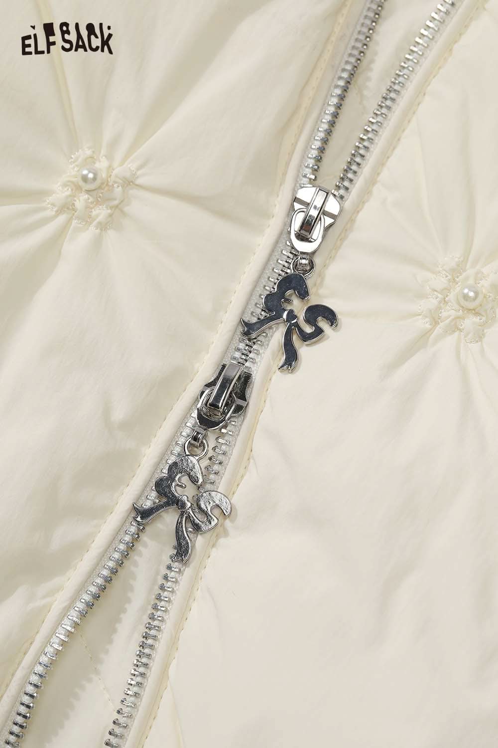 Close-up of ELFSACK cream quilted mid-length jacket showcasing a stylish zipper and soft fabric texture