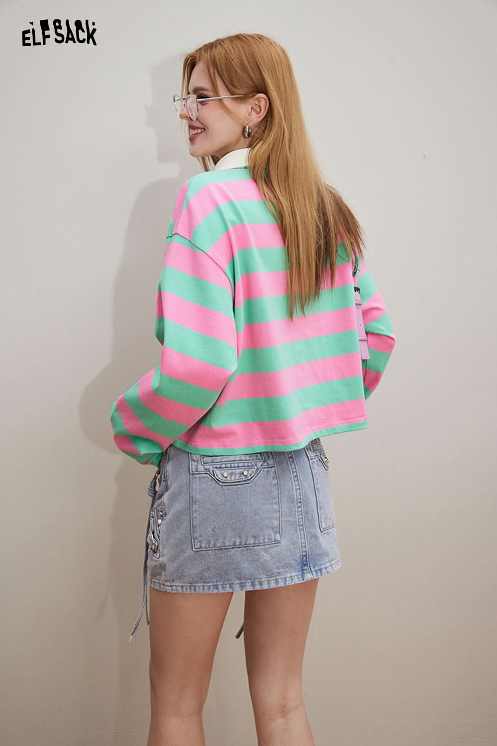 ELFSACK Croche Flower Striped long sleeve t-shirt in pink and green worn by a woman with denim skirt