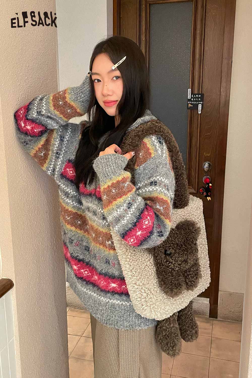 Woman wearing a cozy sweater holding a cute 3D bear shoulder bag for stylish accessorizing