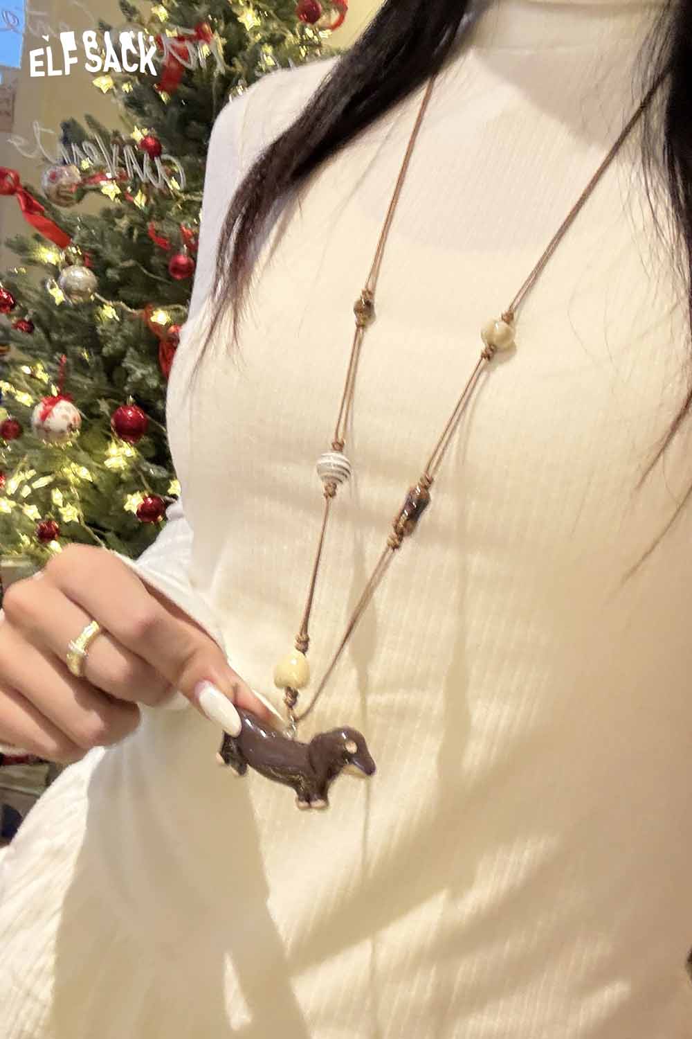 Model wearing a cute dog pendant necklace with a unique design against a festive background