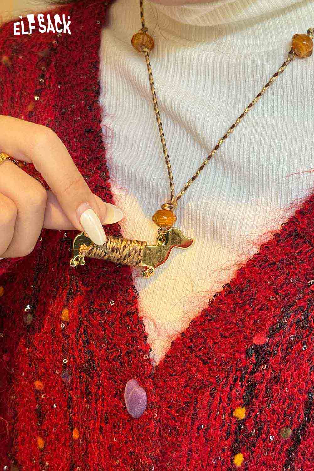 ELFSACK cute dog pendant necklace displayed on a model wearing a cozy red cardigan