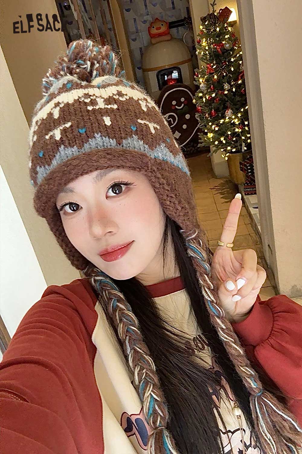 Stylish woman wearing a cute Fair Isle knit beanie with colorful braids at a cozy holiday setting