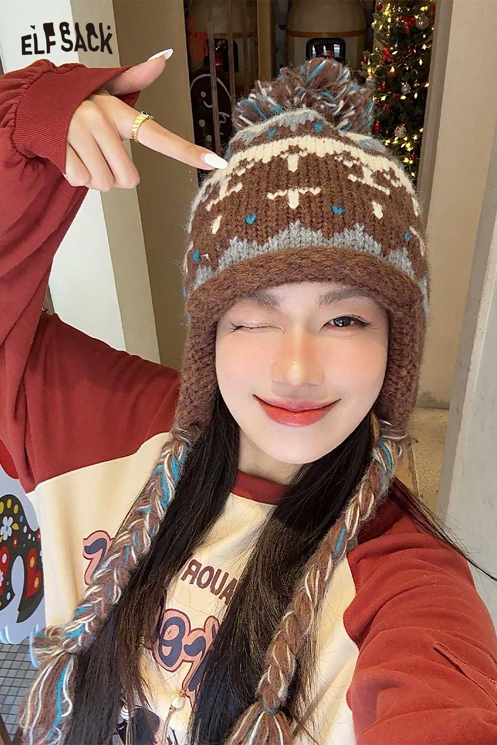 Model wearing a cute Fair Isle knit beanie with colorful patterns and pom-poms for stylish warmth