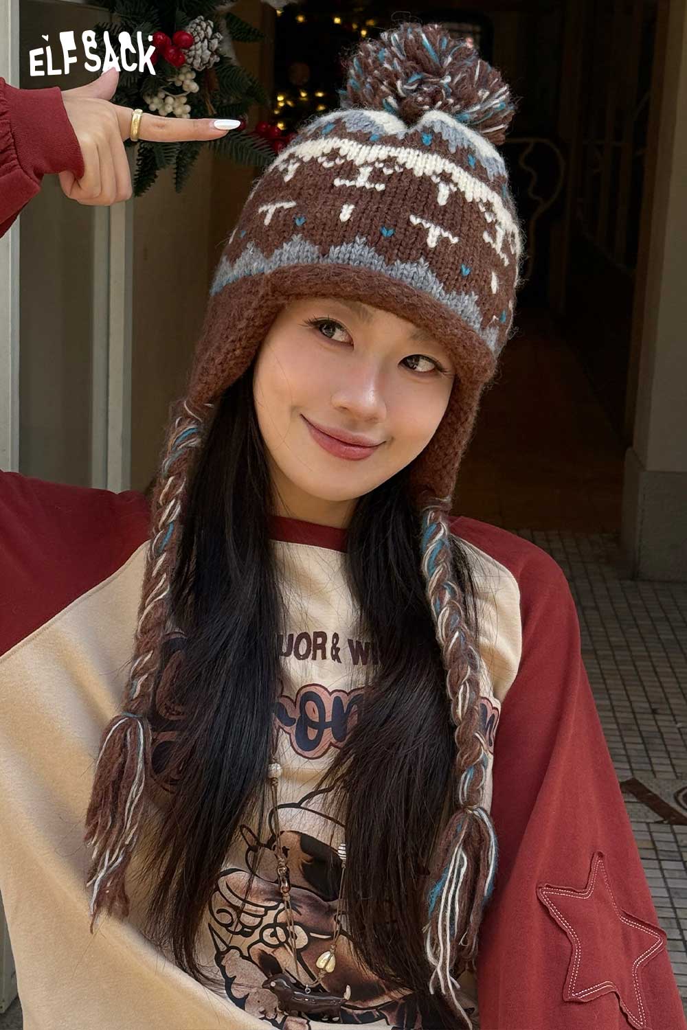 Cute Fair Isle knit beanie in brown with pom-pom and braided tassels for winter style