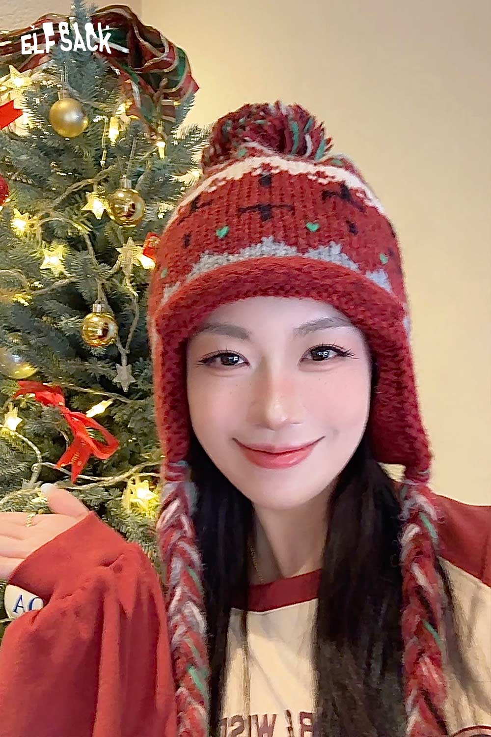 Cute Fair Isle knit beanie in red with pom pom and braided ties, perfect for winter fashion.