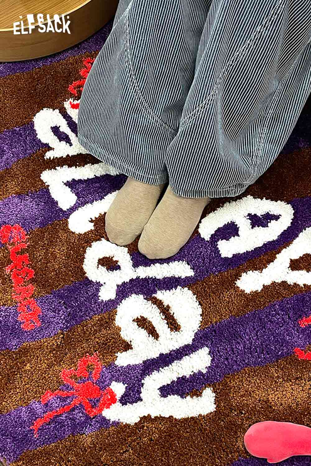 Cute round striped rug from ELFSACK with colorful patterns and soft texture under feet