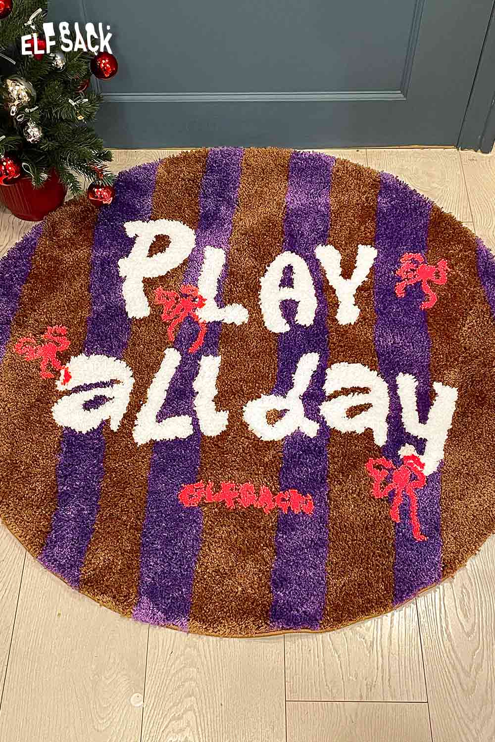 Cute round striped rug with playful text design featuring purple and brown stripes by ELFSACK