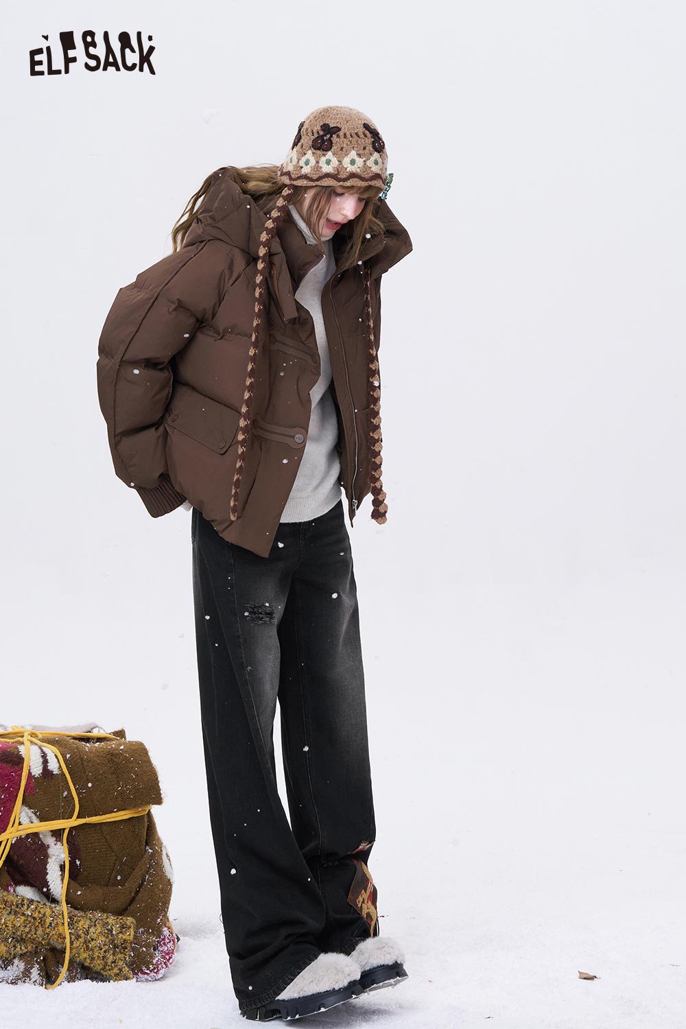 ELFSACK deer patchwork wide leg jeans styled with a warm winter coat in a snowy setting