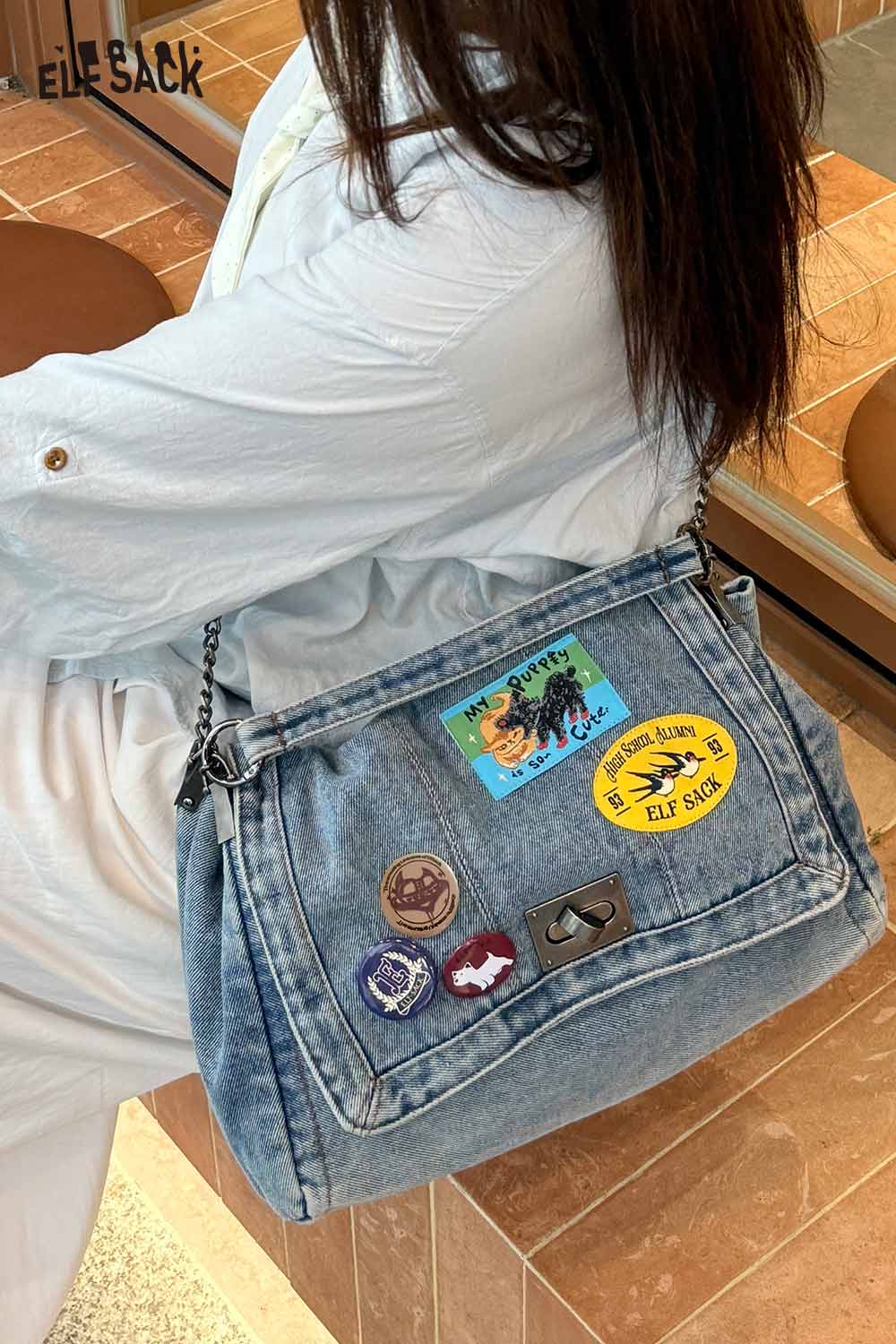 Stylish denim messenger bag for women with colorful patches and a chic chain strap