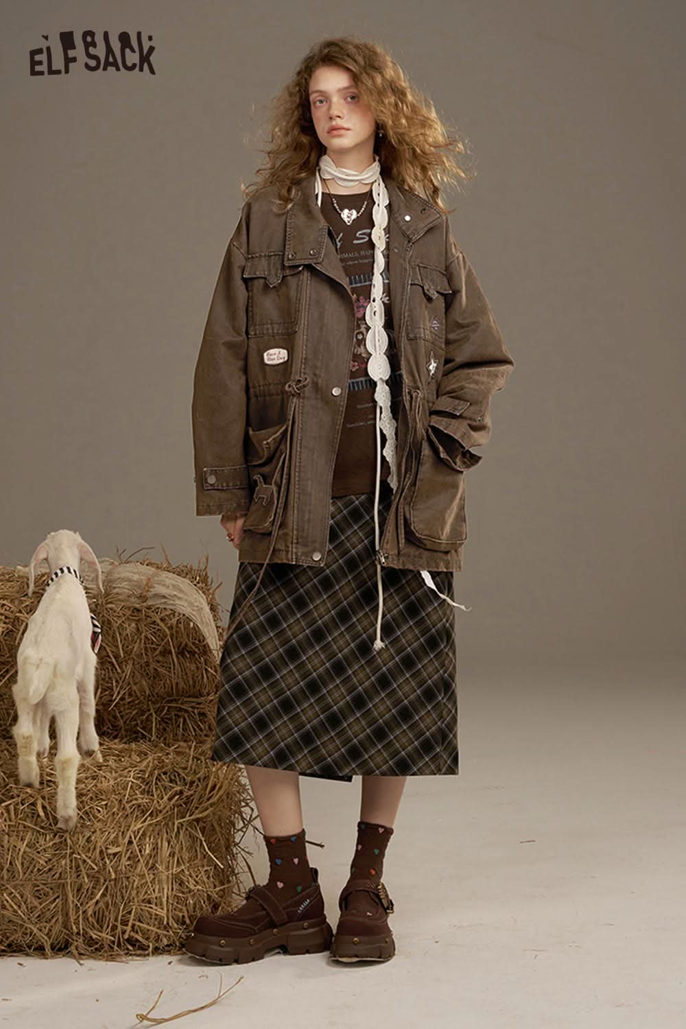 ELFSACK women's loose denim jacket styled with a plaid skirt and chunky boots in a studio setting