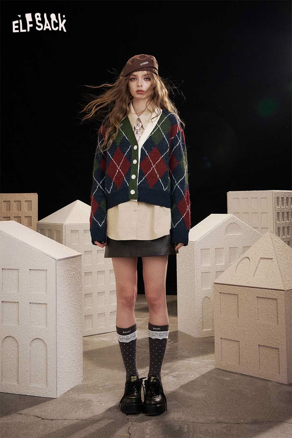 ELFSACK diamond pattern v neck sweater in green, red, and blue, styled with a skirt and knee-high socks