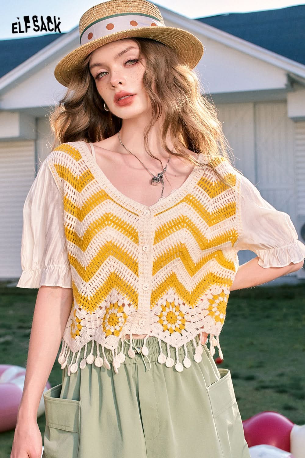 ELFSACK Dopamine Cardigan in Yellow with Crocheted Floral Design and Pom-Pom Trim