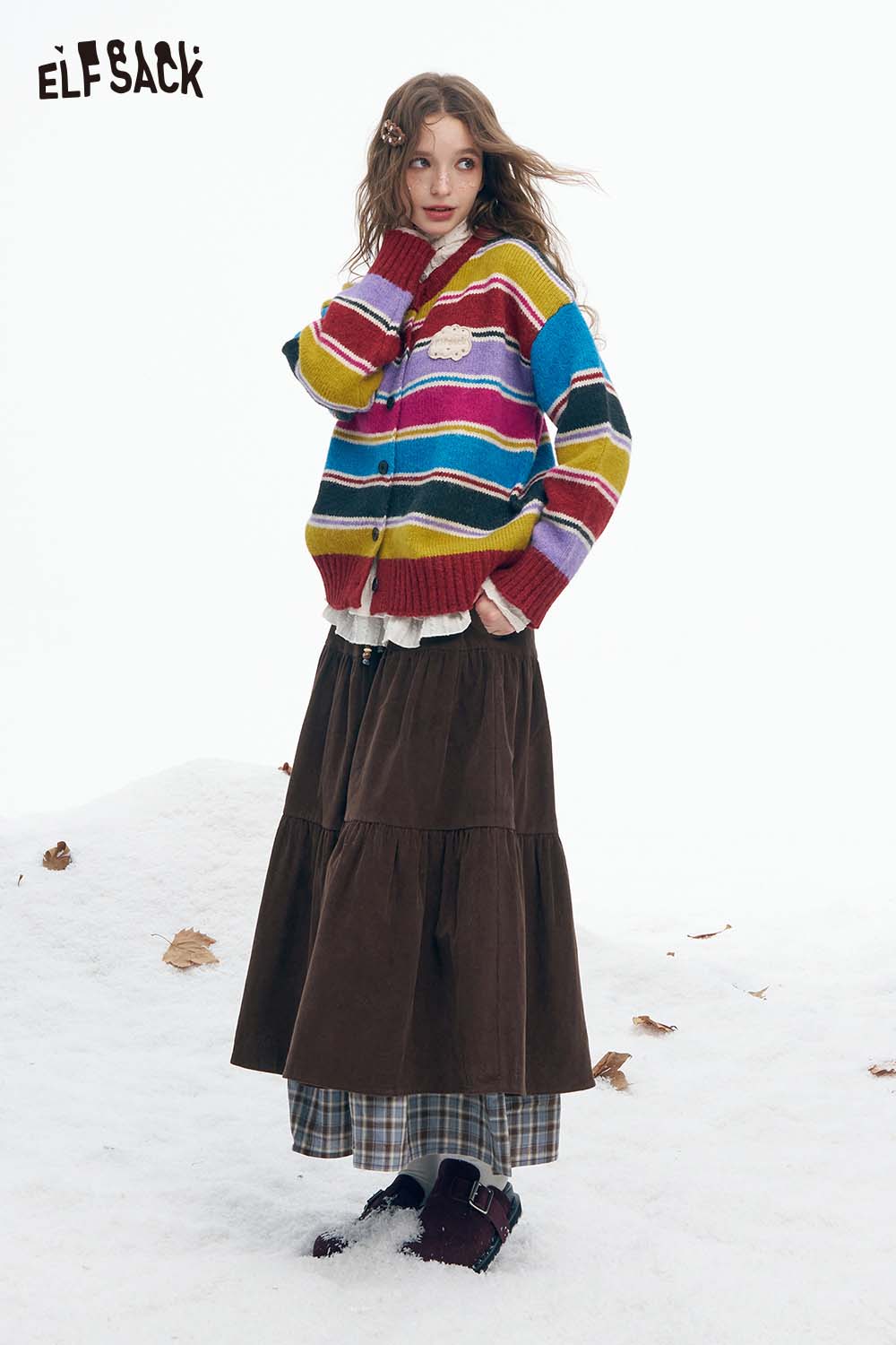 ELFSACK double layer long skirt for women paired with a colorful striped cardigan in a snowy setting